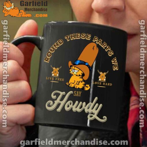 round these parts we love garfiel cowboy black coffee mug